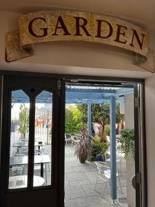 a sign over the door of a garden restaurant at rooms@73 in Waterlooville
