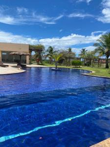 a large pool with blue water in a resort at Santo Mar Em São Miguel do gostoso in Touros