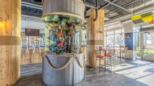 a large wooden exhibit in a room with tables and chairs at Laketown Wharf #1319 by Nautical Properties in Panama City Beach