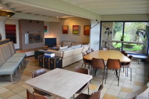 a living room with a couch and a table and chairs at Casa mARTa : Suites, terrasses et vue panoramique in Tournon-sur-Rhône