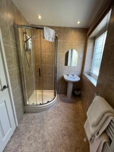 a bathroom with a shower and a sink at Queenswood Hotel in Weston-super-Mare