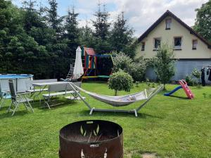a yard with a hammock and a playground at Sielankowo in Kudowa-Zdrój