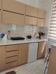 a kitchen with a white counter top and cabinets at Magic Night Apartments in Bar, Susanj
