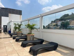 a row of black benches on a building with windows at Suite en Puerto Santa Ana! in Guayaquil