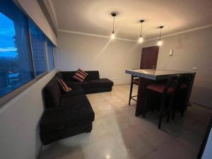 a living room with a couch and a table at Suite en Puerto Santa Ana! in Guayaquil