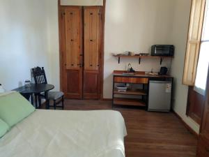 a room with a bed and a desk and a table at La Soñada in La Paz