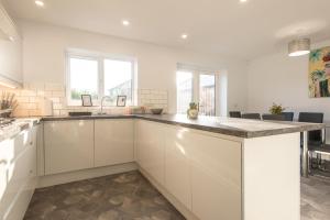 a kitchen with white cabinets and a counter top at No 205 in Doncaster