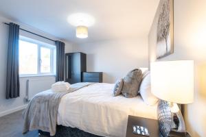 a bedroom with a large bed and a window at No 205 in Doncaster