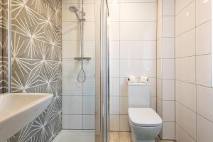 a white bathroom with a toilet and a shower at No 205 in Doncaster