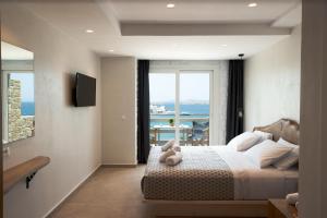 A television and/or entertainment centre at Magic View Suites Mykonos