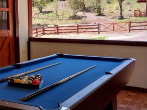 a pool table in a room with a window at Curuba Lodge in El Copey