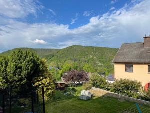 a view of the mountains from a house at Ferienwohnung Zum Wildpark in Edersee