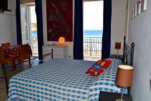 a bedroom with a bed and a view of the ocean at Maridea - Il Delfino in Ponza
