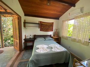 a bedroom with a bed with two pillows on it at Casa nos Algodoes in Marau