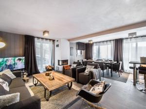 a living room with couches and a dining room at Appartement Courchevel 1650, 3 pièces, 6 personnes - FR-1-563-8 in Courchevel