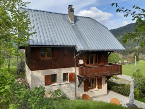 a house with a porch and a balcony at Le Chal'heureux , grand chalet familial 8 personnes in Saint-Pierre-de-Chartreuse