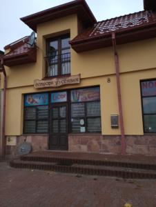 a building with a sign on the front of it at Gospoda Rycerska in Szydłów