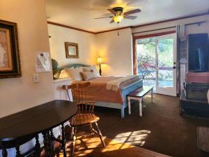 a bedroom with a bed and a table and a window at Oak Hill Inn in Julian