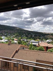 a view from a window of a town with roofs at Apartamentos DELUXE Con Jacuzzi o Chimenea LOVE FOR TWO in Collado Mediano