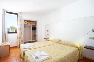 Łóżko lub łóżka w pokoju w obiekcie Apartamentos Don Quijote