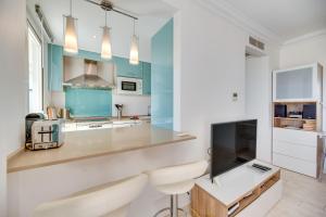 a kitchen with white countertops and blue cabinets at Marina Banus in Marbella