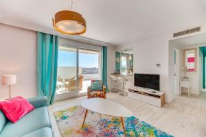a living room with a blue couch and a table at Marina Banus in Marbella