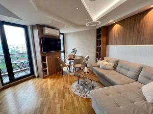 a living room with a couch and a table at Maria's Elite Luxury Apartment Skopje in Skopje