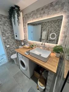 uma casa de banho com um lavatório e uma máquina de lavar roupa em Studio cosy avec terrasse sur la plage em La Seyne-sur-Mer
