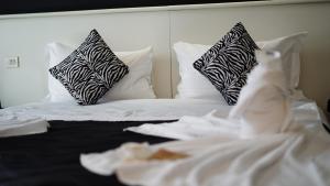 a white bed with black and white pillows at Hotel Nuovo Sole HNS in Bovolone +72 photos
