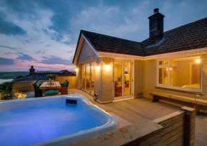 a hot tub on the deck of a house at Pencarreg in Polruan