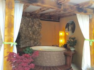 a bath tub in a room with a stone wall at Villa Barbara in Skradin +73 photos