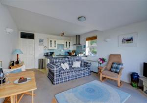uma sala de estar com um sofá e uma mesa em Blue Horizon em St Ives