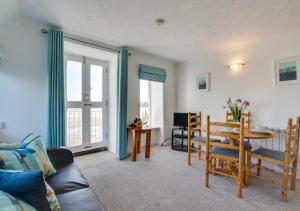 a living room with a table and a couch at 1 Copper Kettle Apartment in St Ives