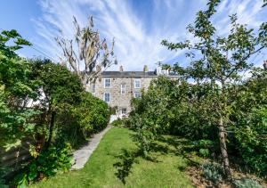 an old house with a garden in front of it at Stargazy in Mousehole