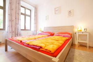 een slaapkamer met een groot bed en een gele deken bij Wohfühlen Garantiert in Görlitz