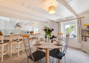 a kitchen and dining room with a table and chairs at Shillingstones in Saint Teath