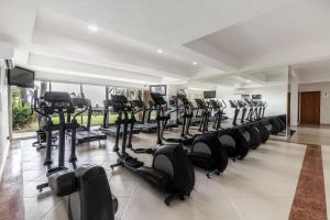 a gym with a row of treadmills and exercise bikes at Ocean front Grand Venetian corner condo in Puerto Vallarta