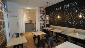 a restaurant with tables and chairs and a black wall at Old Kings Design Hostel in Füssen