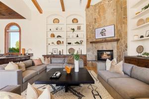 a living room with couches and a fireplace at The Zenda Estate in Indio