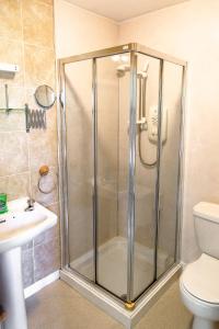 a bathroom with a shower with a sink and a toilet at Dunfallandy House Hotel in Pitlochry