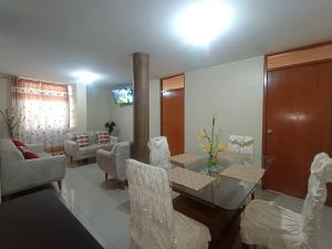 a living room with a glass table and chairs at LUANA’S HOUSE in Ica