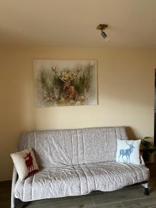 a couch in a living room with a picture of a deer at mountain house the deer in Tesero
