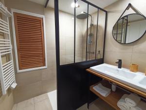 a bathroom with a sink and a mirror at La maison de la Traverse in Saint-Guilhem-le-Désert