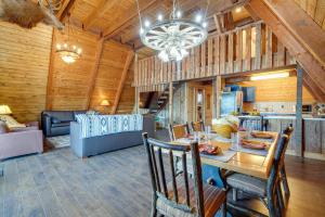 a dining room and living room with a table and chairs at Lakefront A-Frame Cabin with Community Perks in Columbia