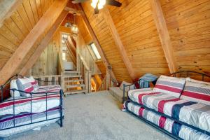 A bed or beds in a room at Lakefront A-Frame Cabin with Community Perks