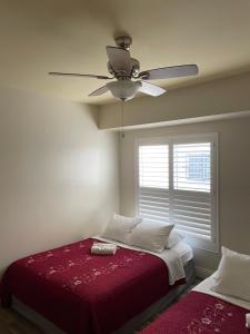 a bedroom with a bed and a ceiling fan at Private Los Angeles Room - Free WIFI, AC, TV, Private Fridge, Kitchen, near USC - Exposition Park - USC Memorial Coliseum - Banc of California BMO Stadium - Downtown Los Angeles DTLA - University of Southern California USC!!! in Los Angeles