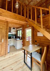 a dining room and kitchen in a log cabin at Mountain Eco Shelter 9 in Funchal