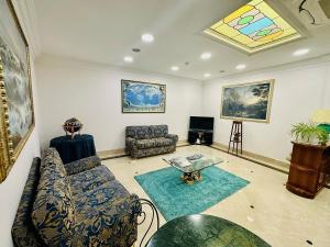 a living room with a couch and a table at Hotel Principe Di Piemonte in Rome
