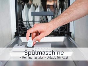 a hand is pushing a button on a dishwasher at Bergliebe - Talstation in Blaichach