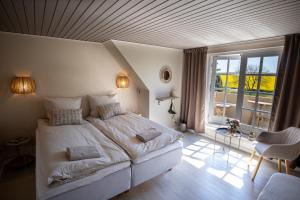 a bedroom with a large bed and a large window at Mosters Bed & Breakfast in Guldborg